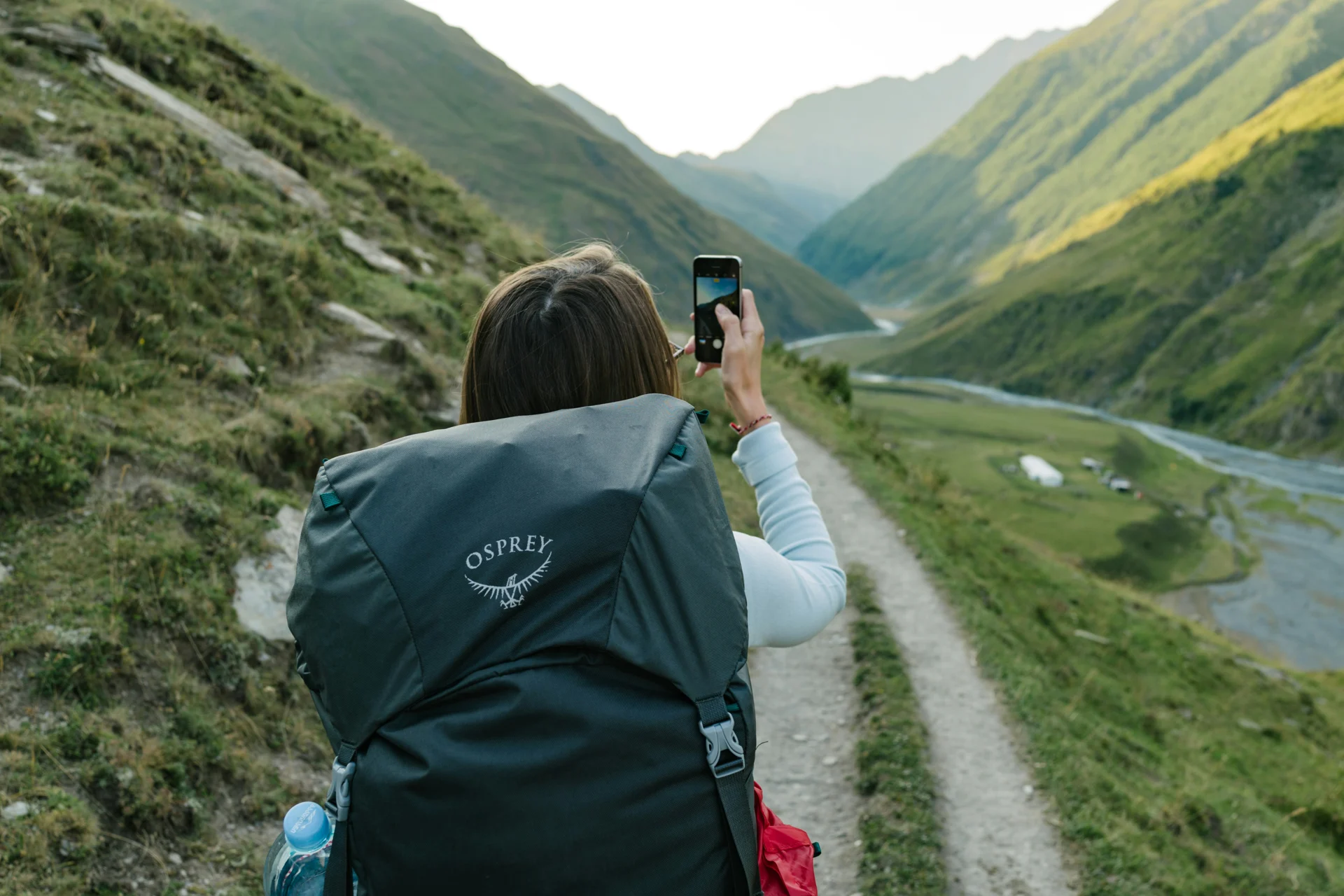 A traveler exploring a green mountain valley